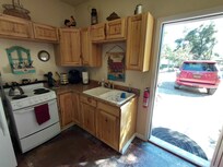 Fully equipped kitchenette. So you're better prepared, the stove is not full size. Fridge/freezer is next to stove.