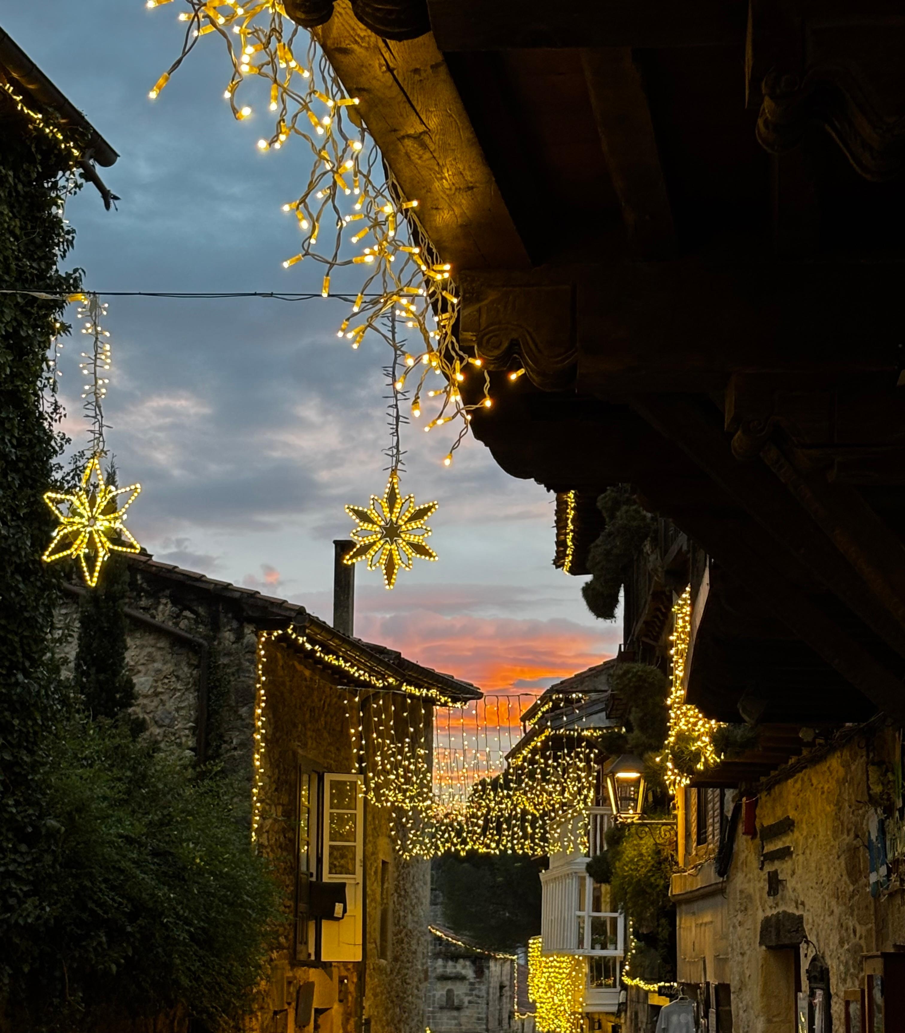 Santillana Del Mar holiday lights at sunset. 