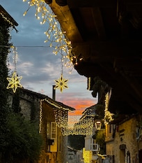 Santillana Del Mar holiday lights at sunset.