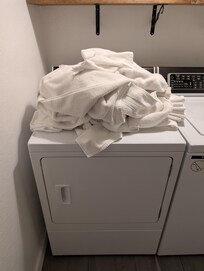 Dirty towels on top of the dryer