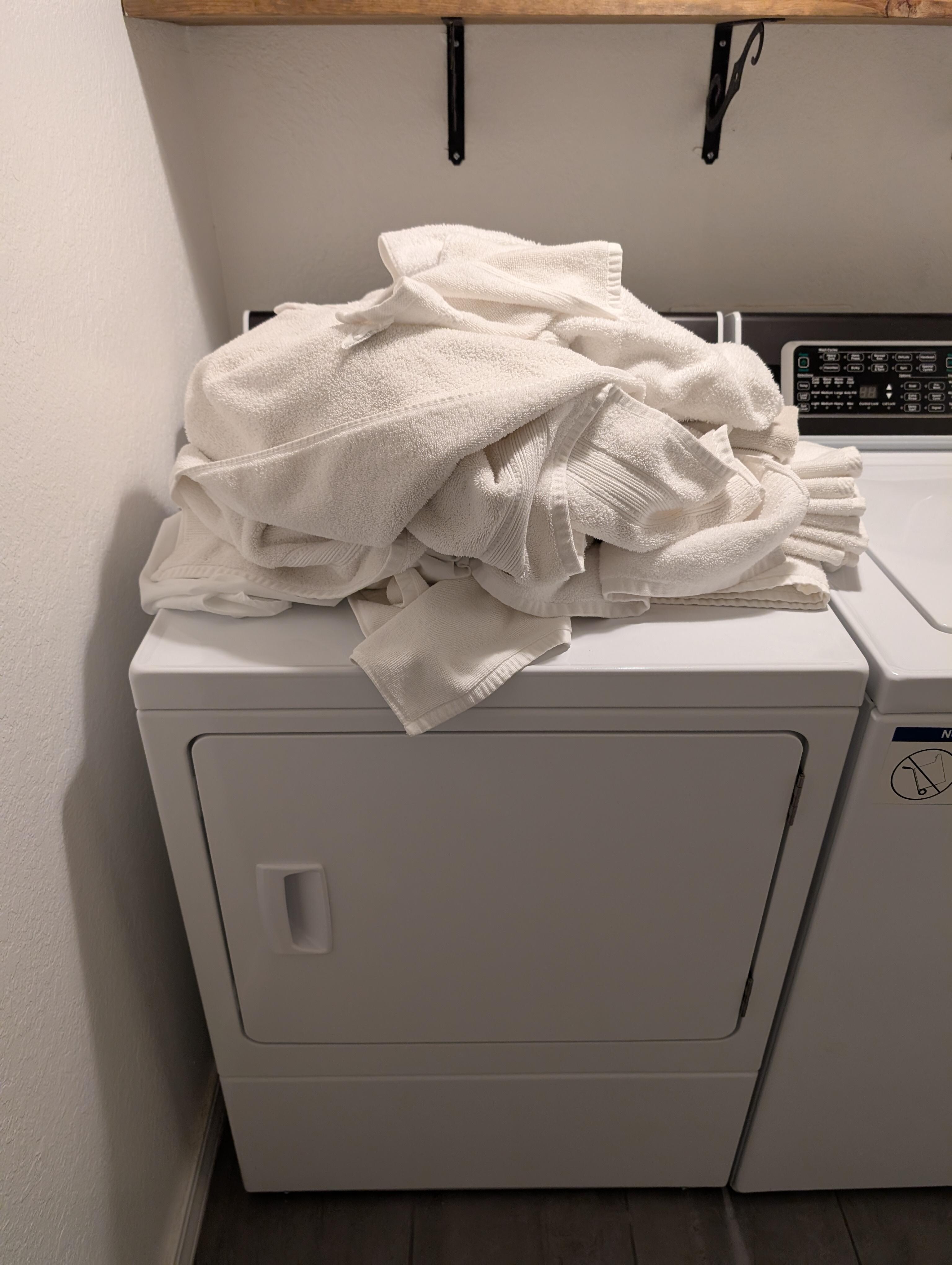 Dirty towels on top of the dryer 