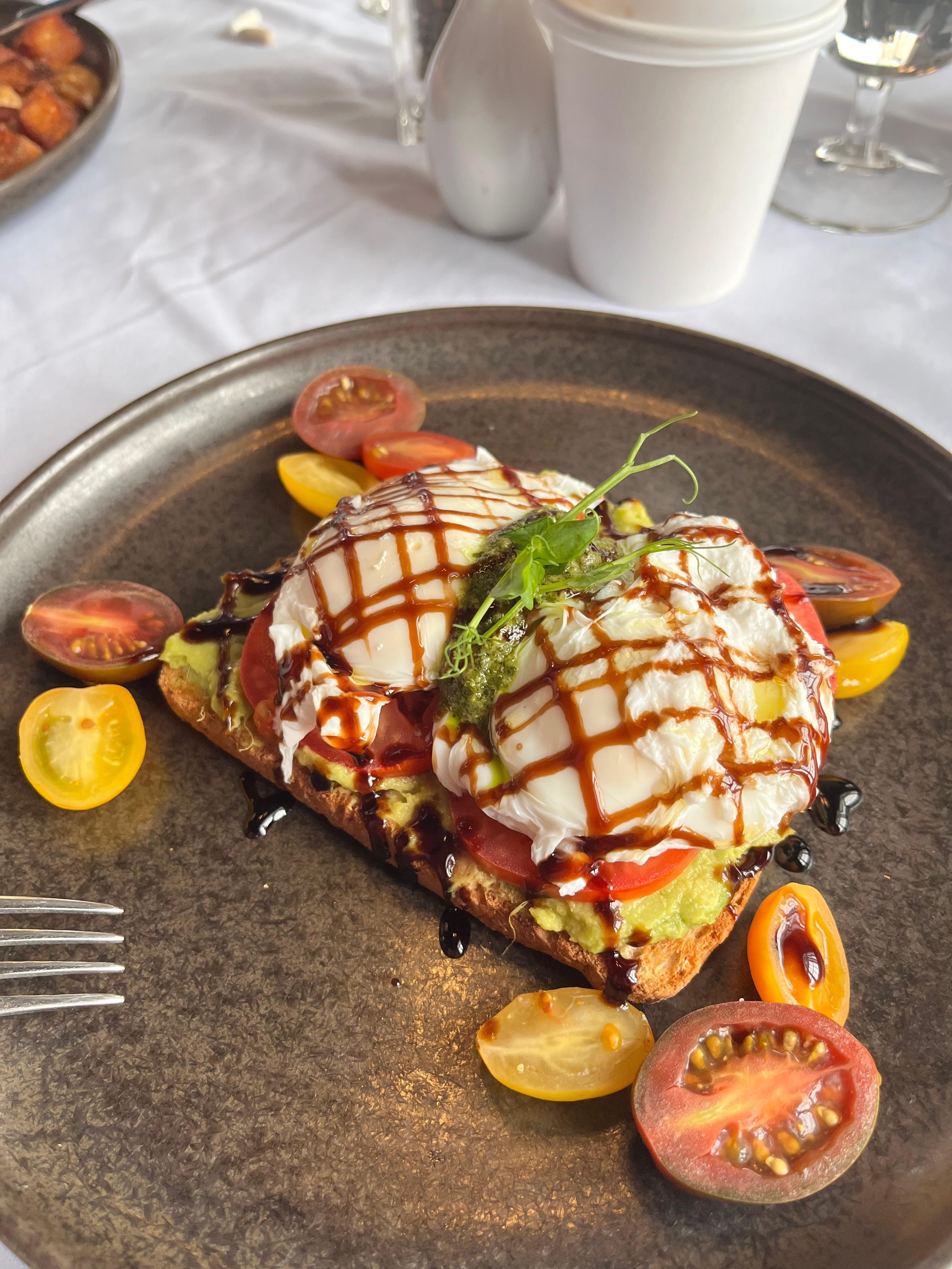 Breakfast in the restaurant. Avocado toast with poached eggs. 