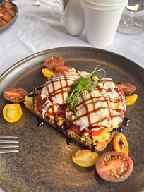 Breakfast in the restaurant. Avocado toast with poached eggs.