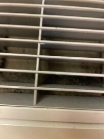 caked on layer of dust in air conditioner vent