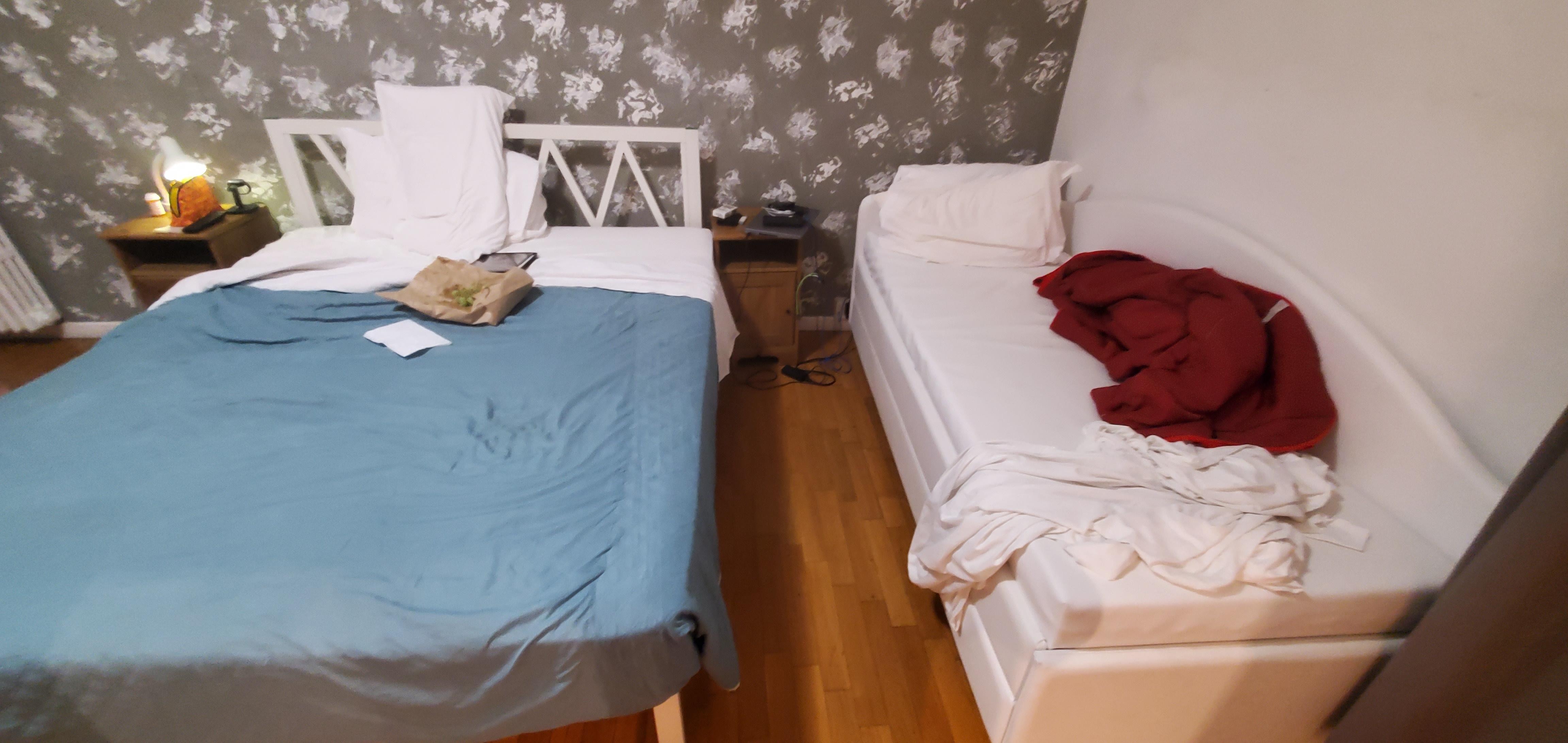 This is the twin room... a bed and a leather bench