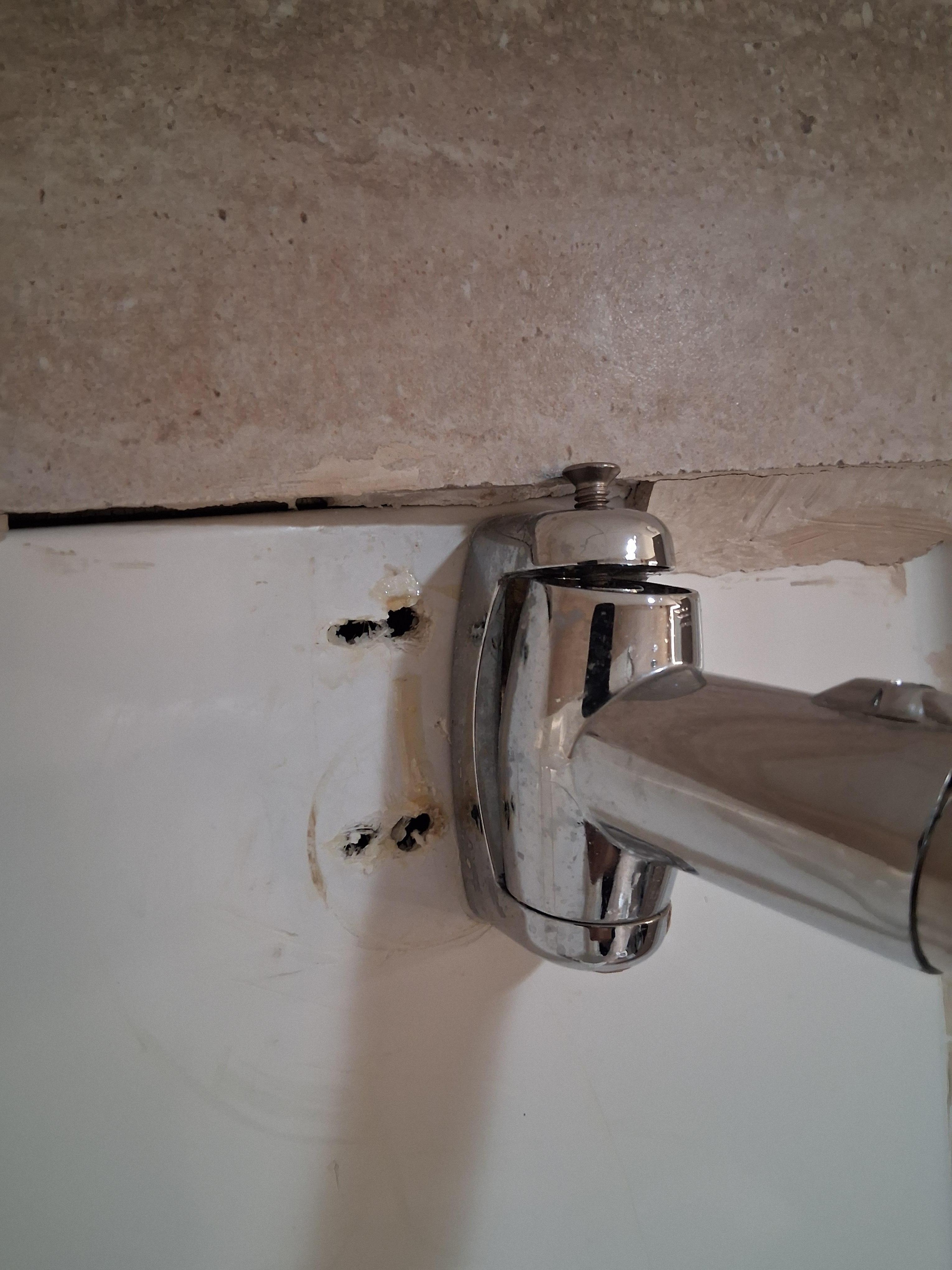 The installation of the shower curtain rod was poorly done; the rod was tilted 15 degrees and was not securely fastened, but moved up and down.