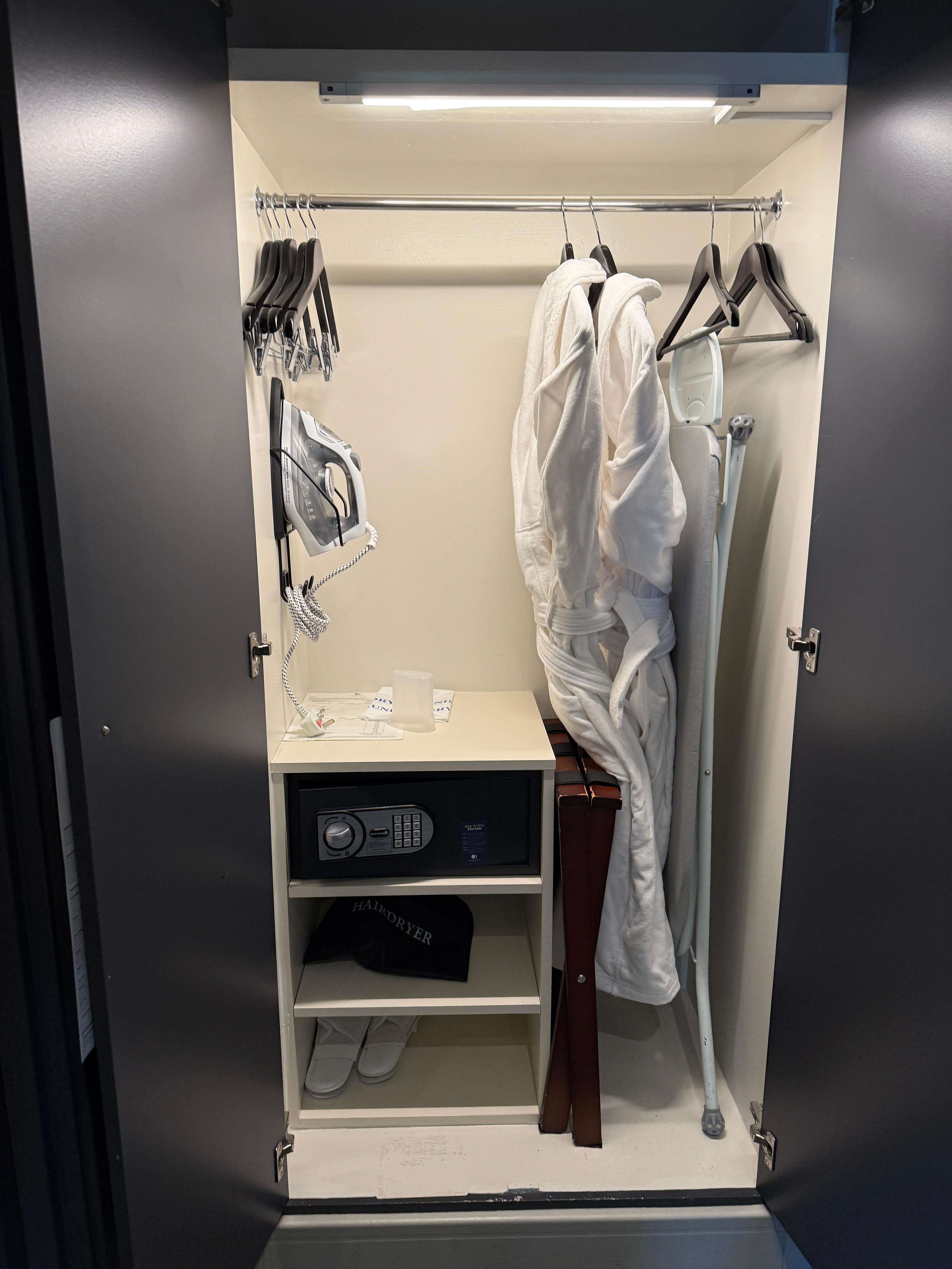 Closet with safe, iron & ironing board, robes and slippers
