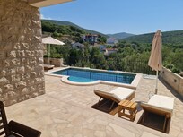 View from the rear french windows over the pool