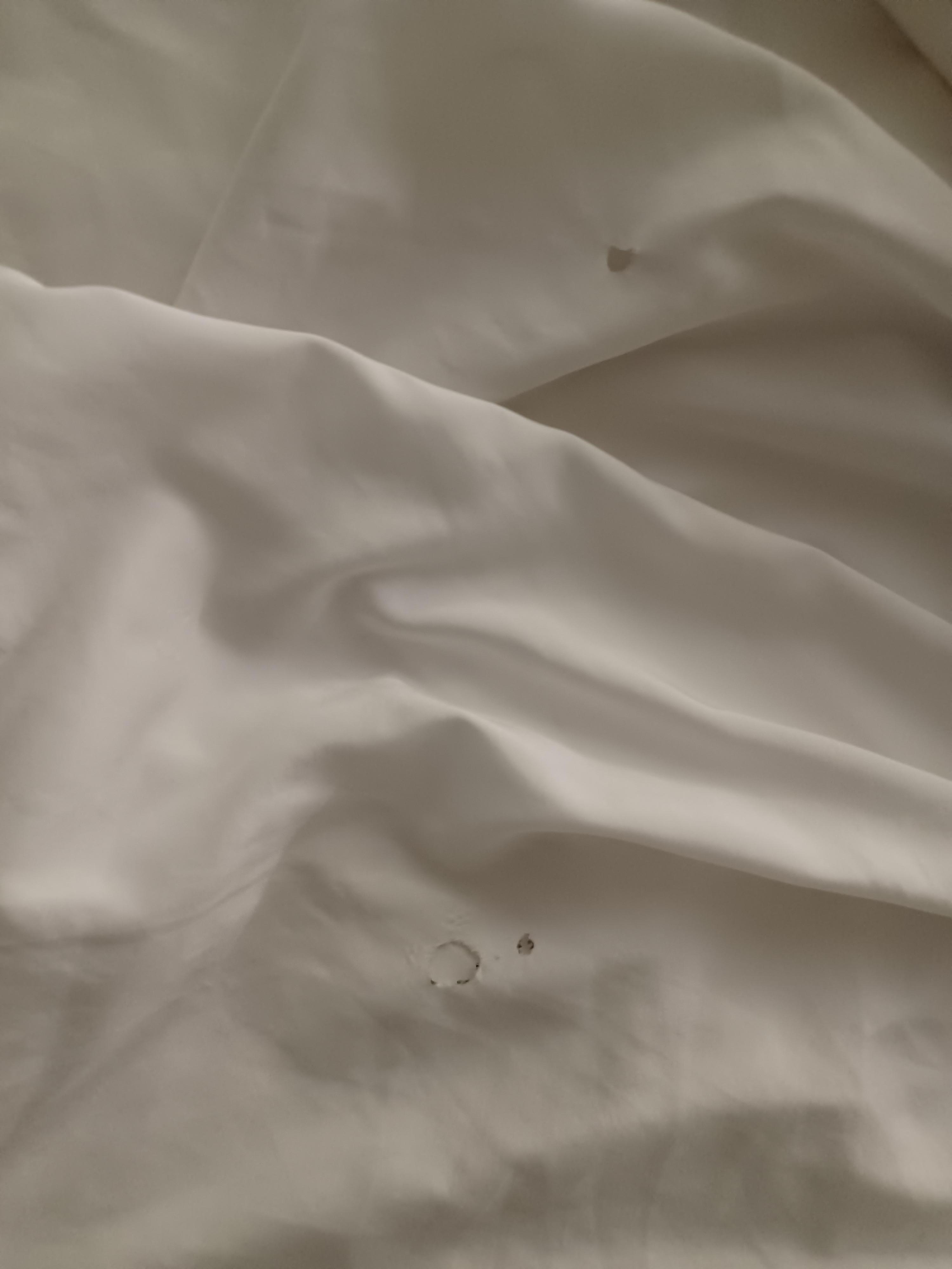 Cigarette holes in sheet