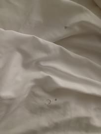 Cigarette holes in sheet