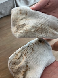Ruined socks from rusty water leaking through floor