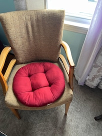 Worn out chair with cushion for seating