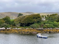 White house to left of photo where the flat is situated on the upper floor.