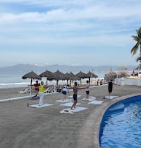 Yoga by the pool on the sand