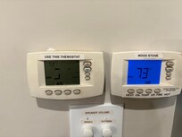 The thermostat on the left controls the AC, and half the display is burnt out, making it impossible to use.