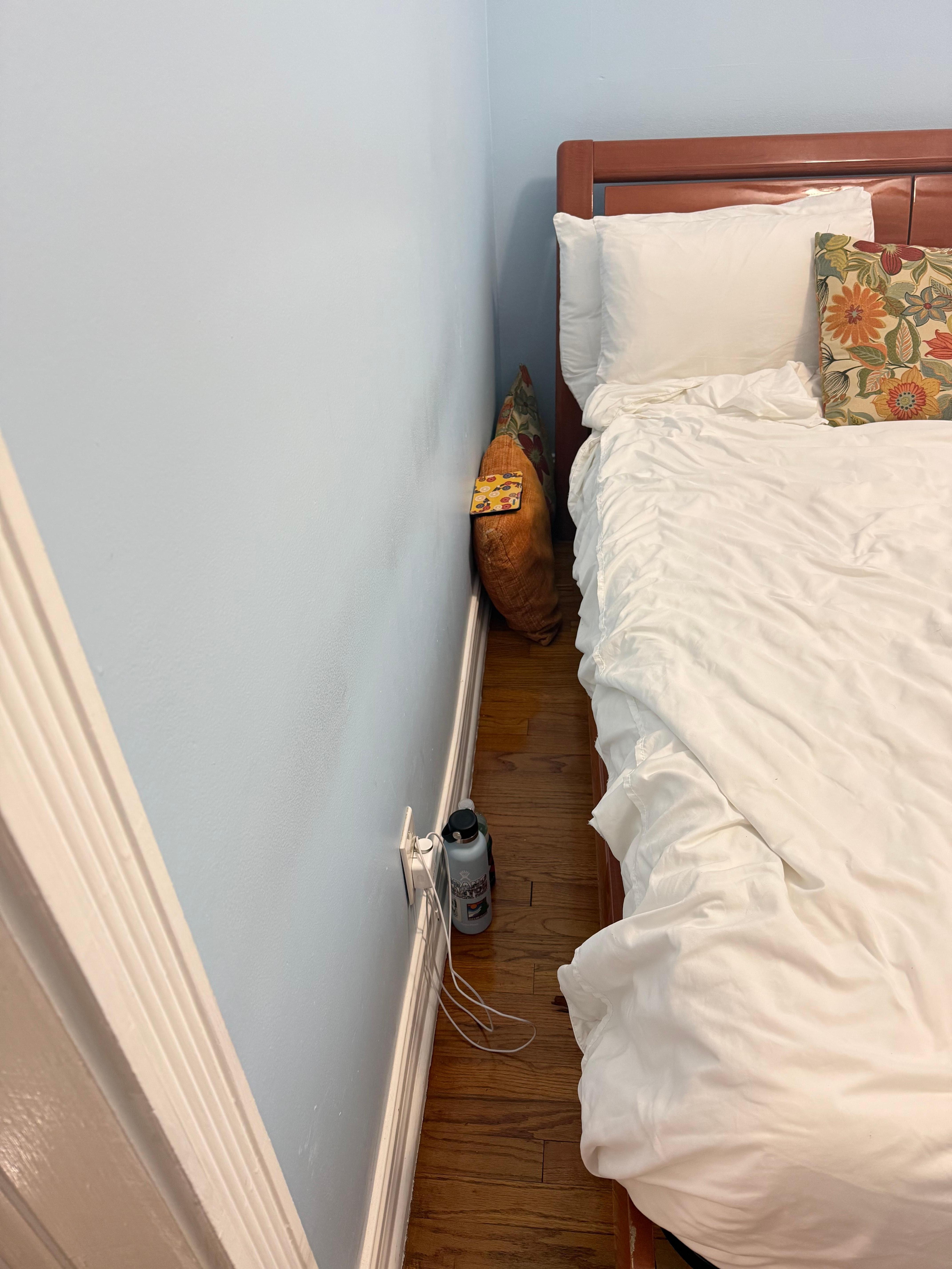 No space, night stand, or place to plug in phone.