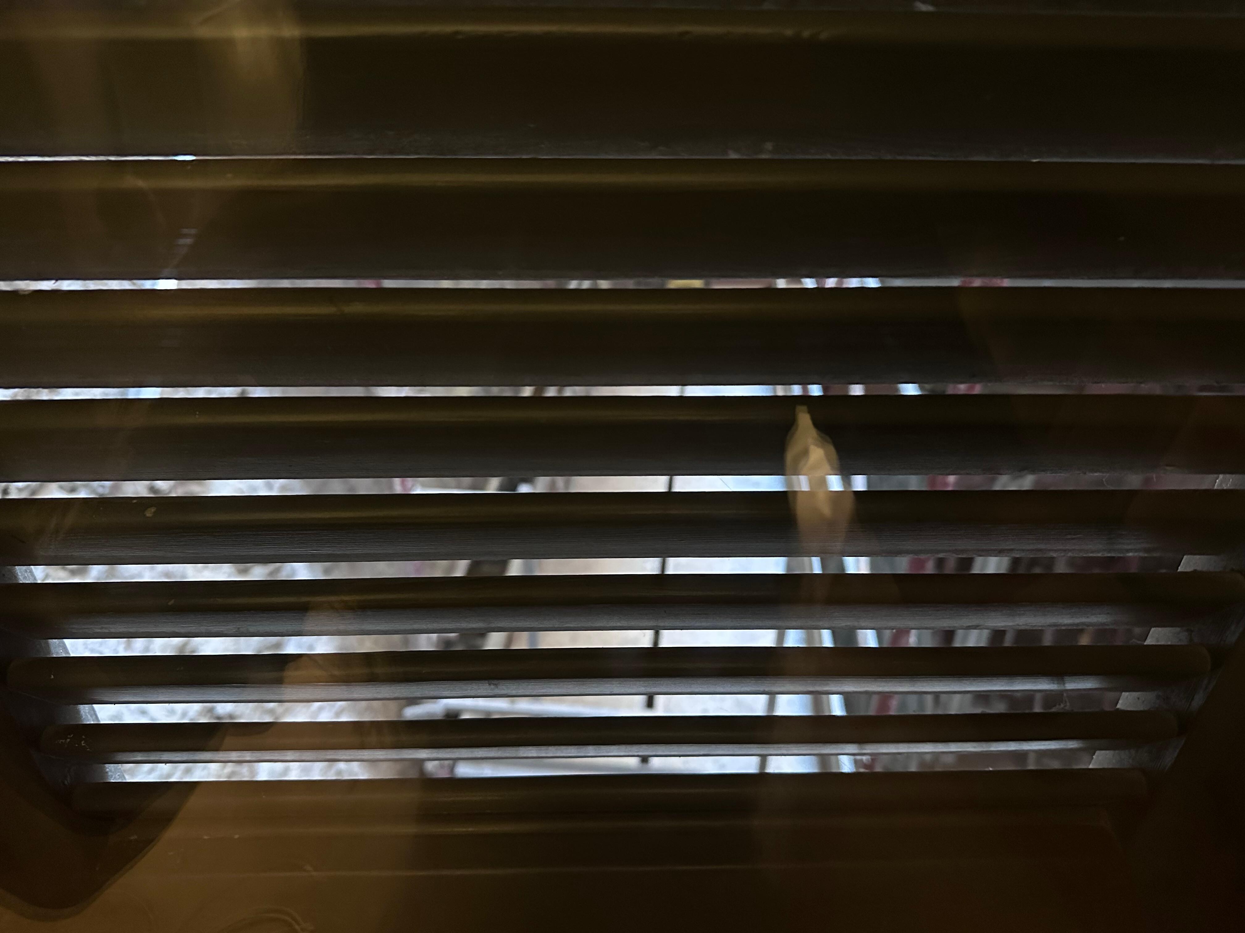 View available through shutter blades, scaffolding directly outside