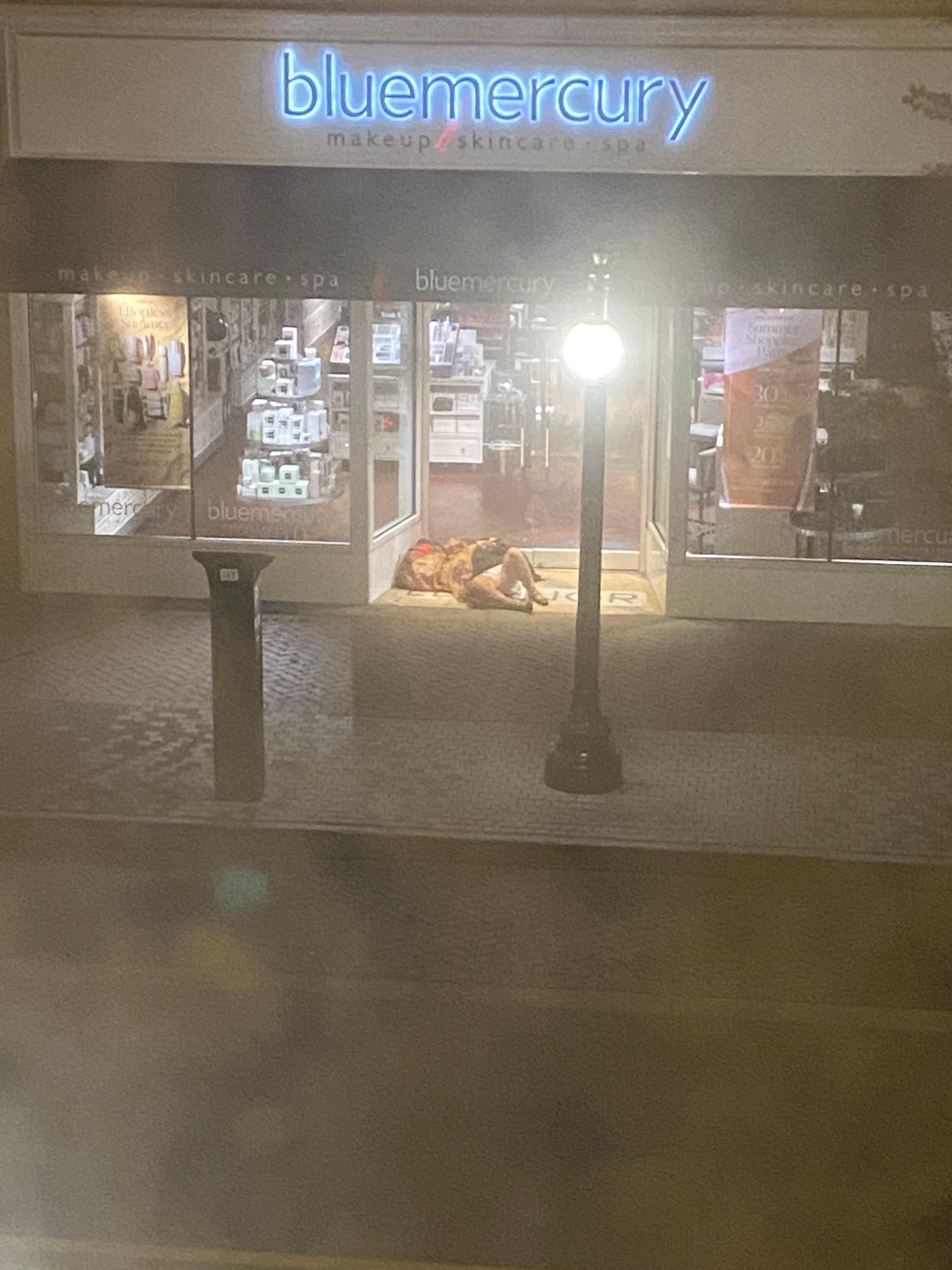 Homeless individual sleeping right across the street. 