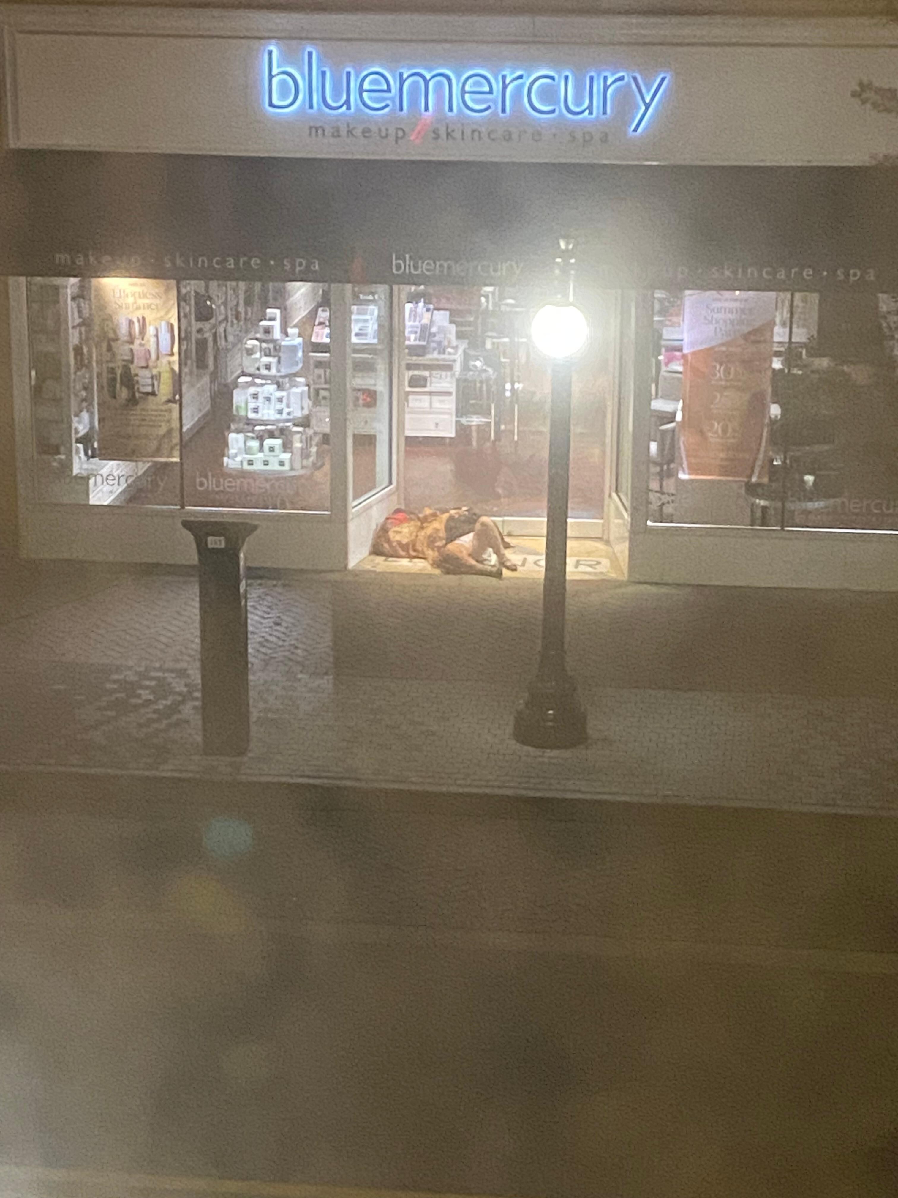 Homeless individual sleeping right across the street. 
