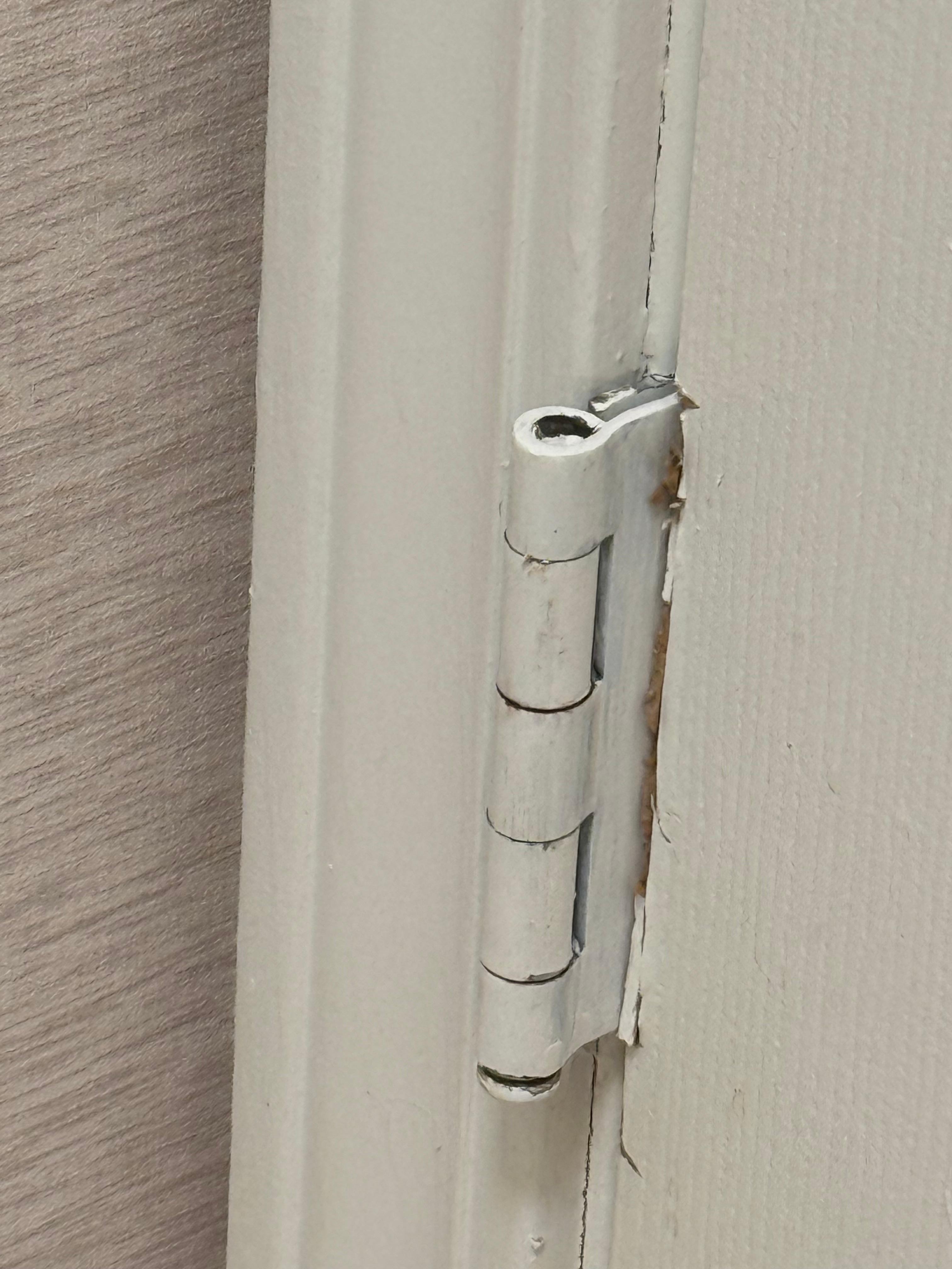 The bathroom door does not shut properly. The hinge is upside down.