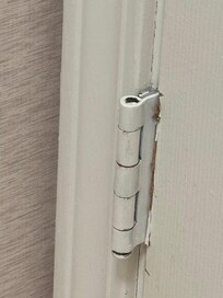 The bathroom door does not shut properly. The hinge is upside down.