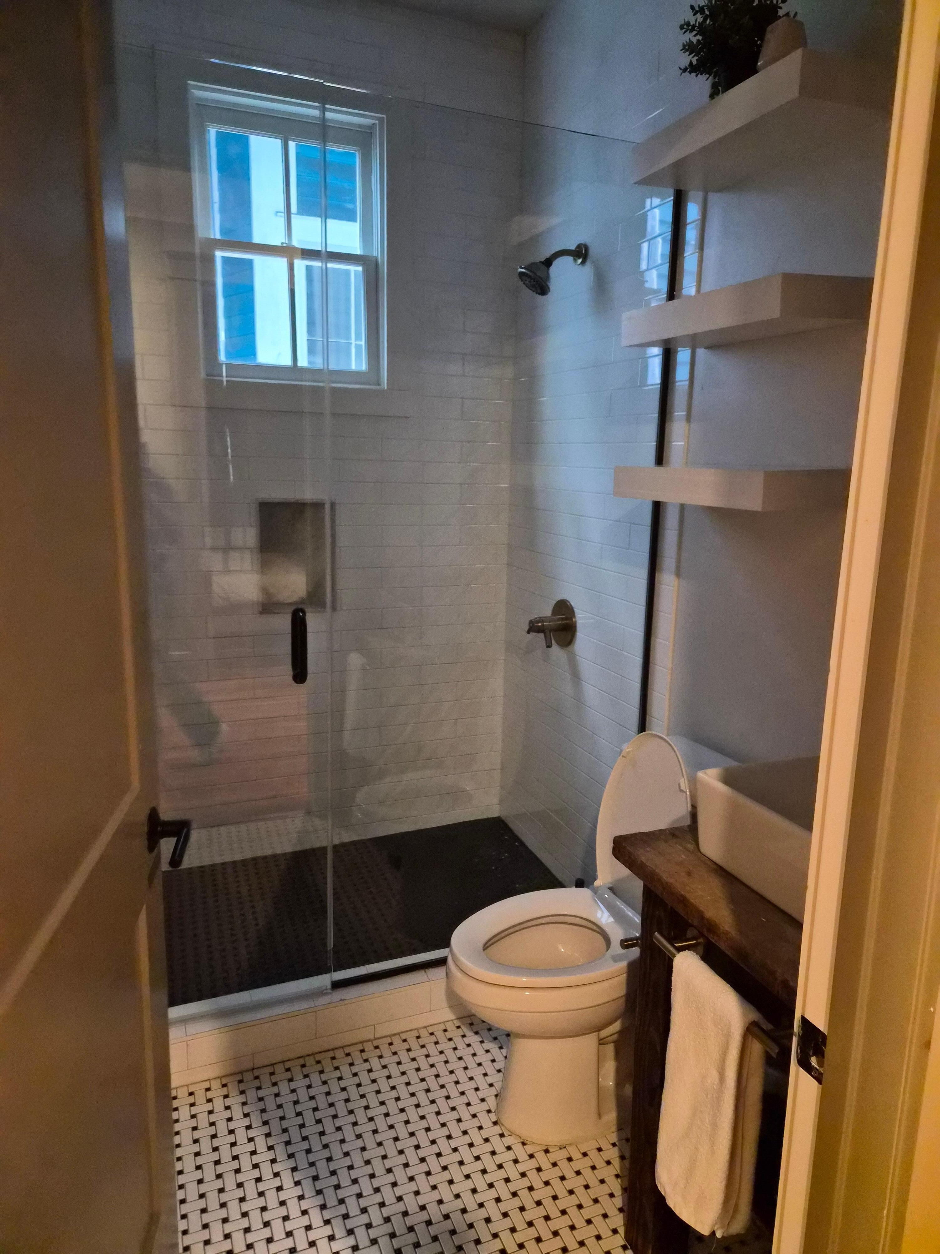 No window treatment in bathroom with neighboring window right there