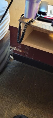 By the head of the bed