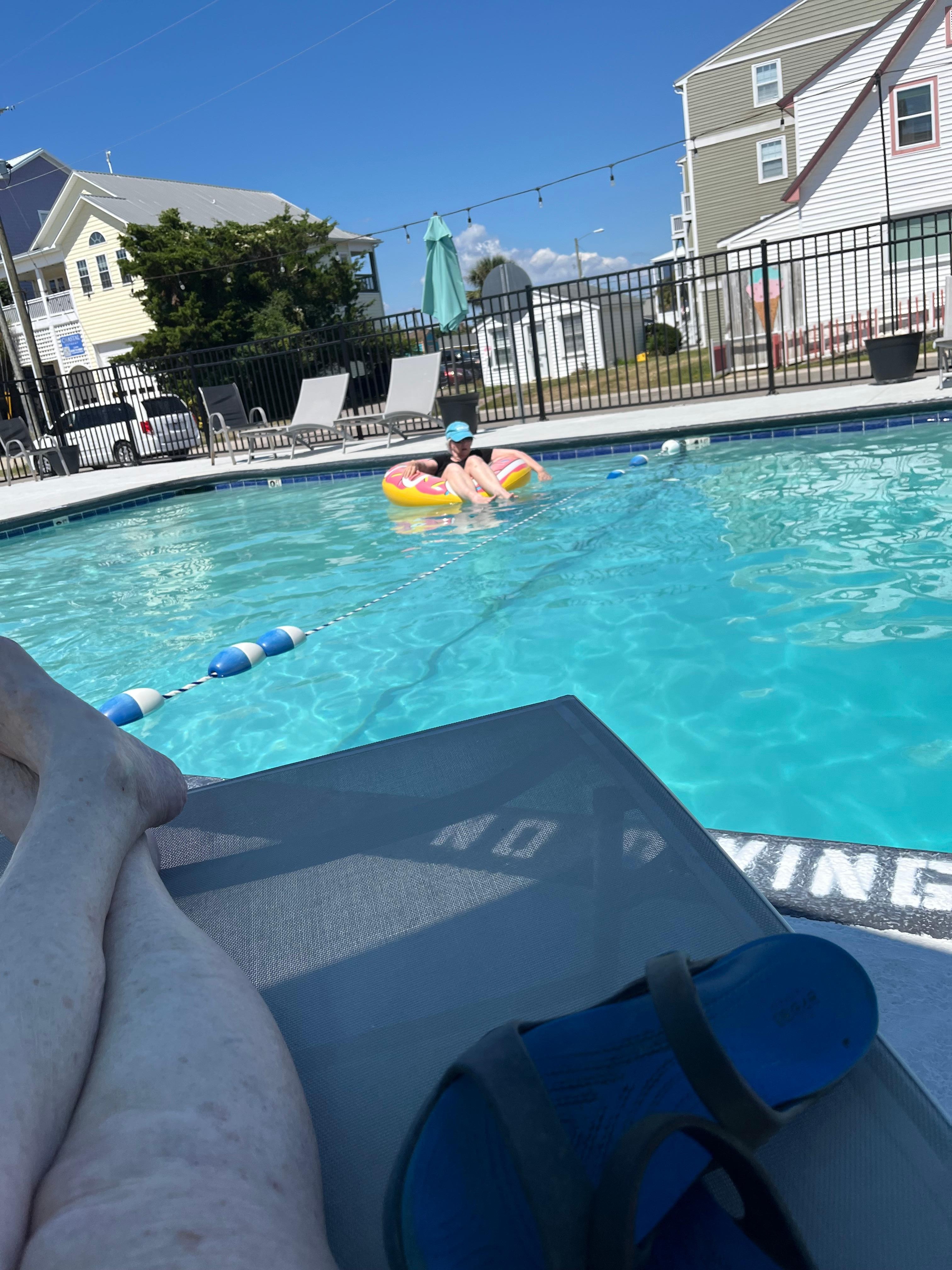 My sister floating in the pool