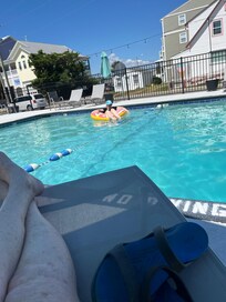 My sister floating in the pool