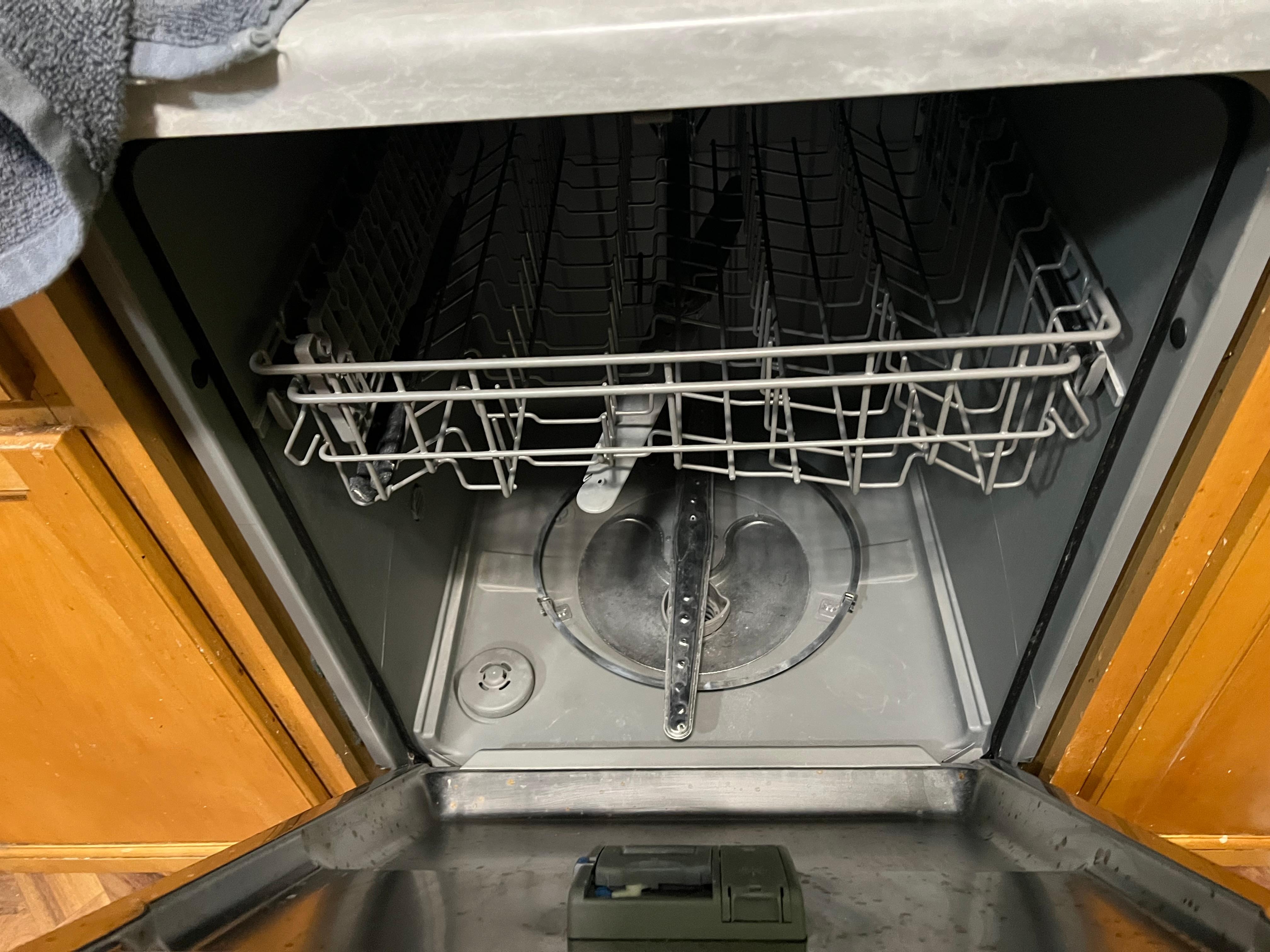 Dishwasher without the bottom rack….note we did see the rack on the shelf on the outside patio