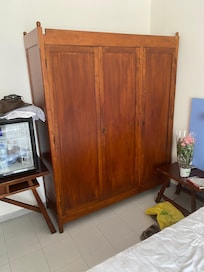 very dated wardrobe with a few odd hangers