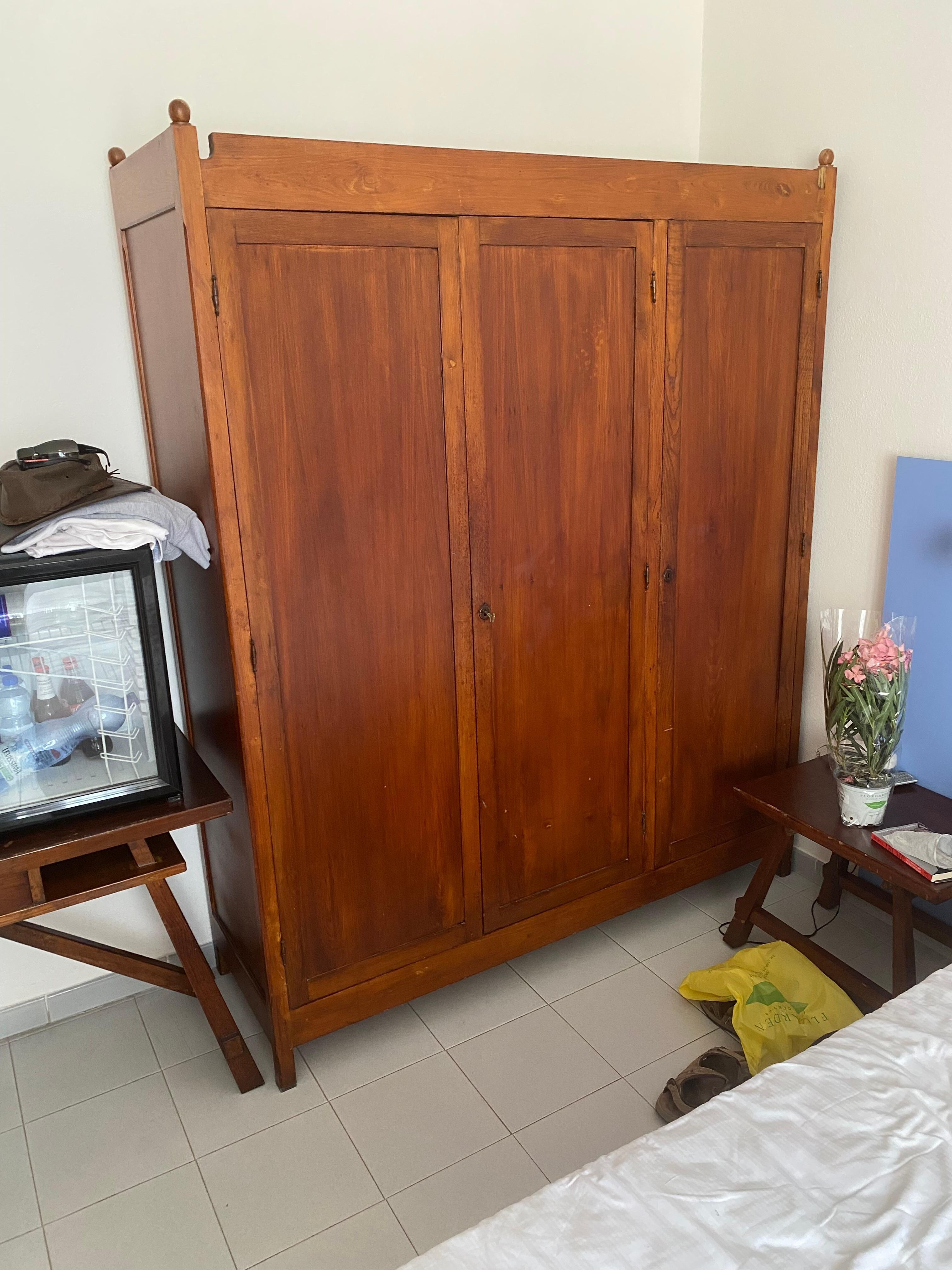 very dated wardrobe with a few odd hangers