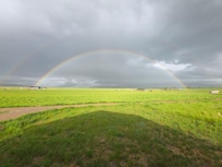 Double rainbow over the nearby ranches viewed from the Shedhorn cabins.