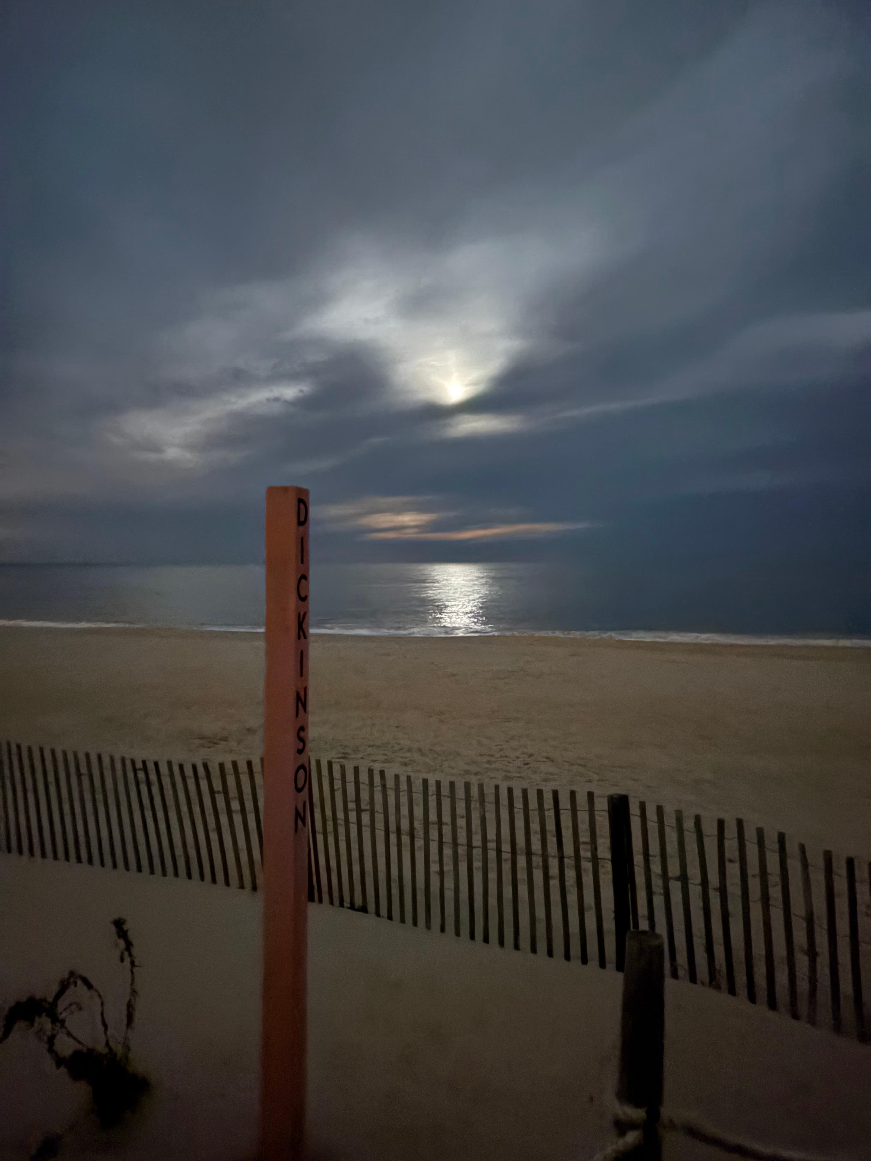 Full moon on a cloudy night at the ocean 