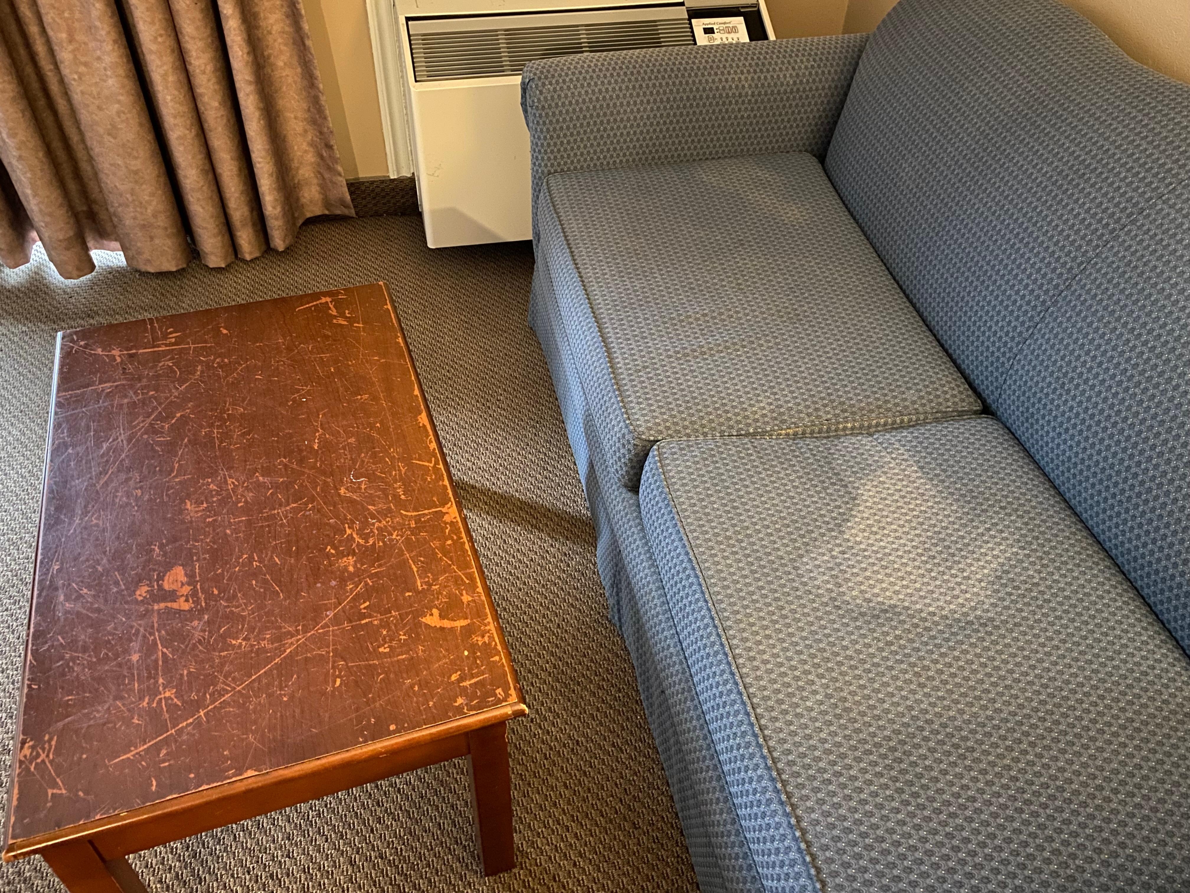 The table is covered in scratches, round on the curb I’m sure. Look at the couch?! 
