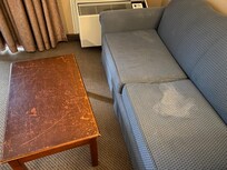 The table is covered in scratches, round on the curb I’m sure. Look at the couch?!