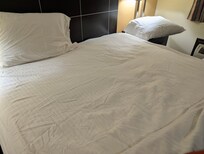 The bed was left in use by the previous guest.