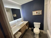 Photos shows bathroom with wonderful design and storage.