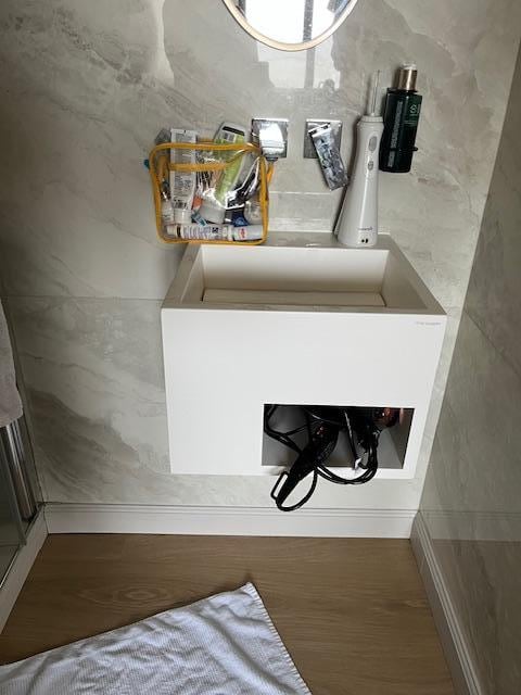 No shelf for toiletries or a towel rack, threw towel over shower door beside sink.