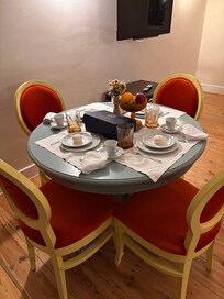 Table set with coffee supplies, macaroon, and linens.