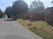 The wall opposite the church in the village. I believe it's called crinkle crinkle wall
