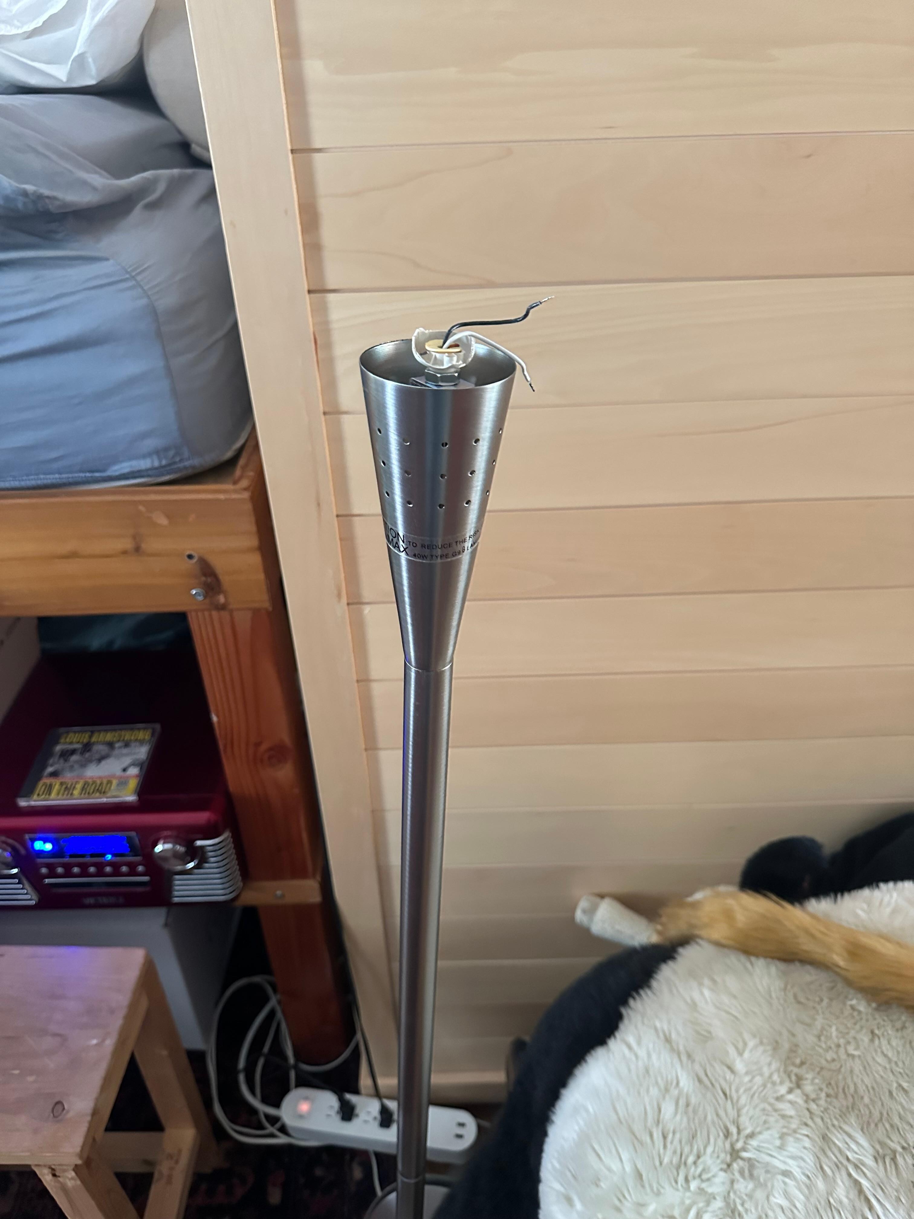 Lamp with exposed wires in main area of playroom