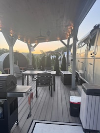 Deck, table, grill, and sauna on the left