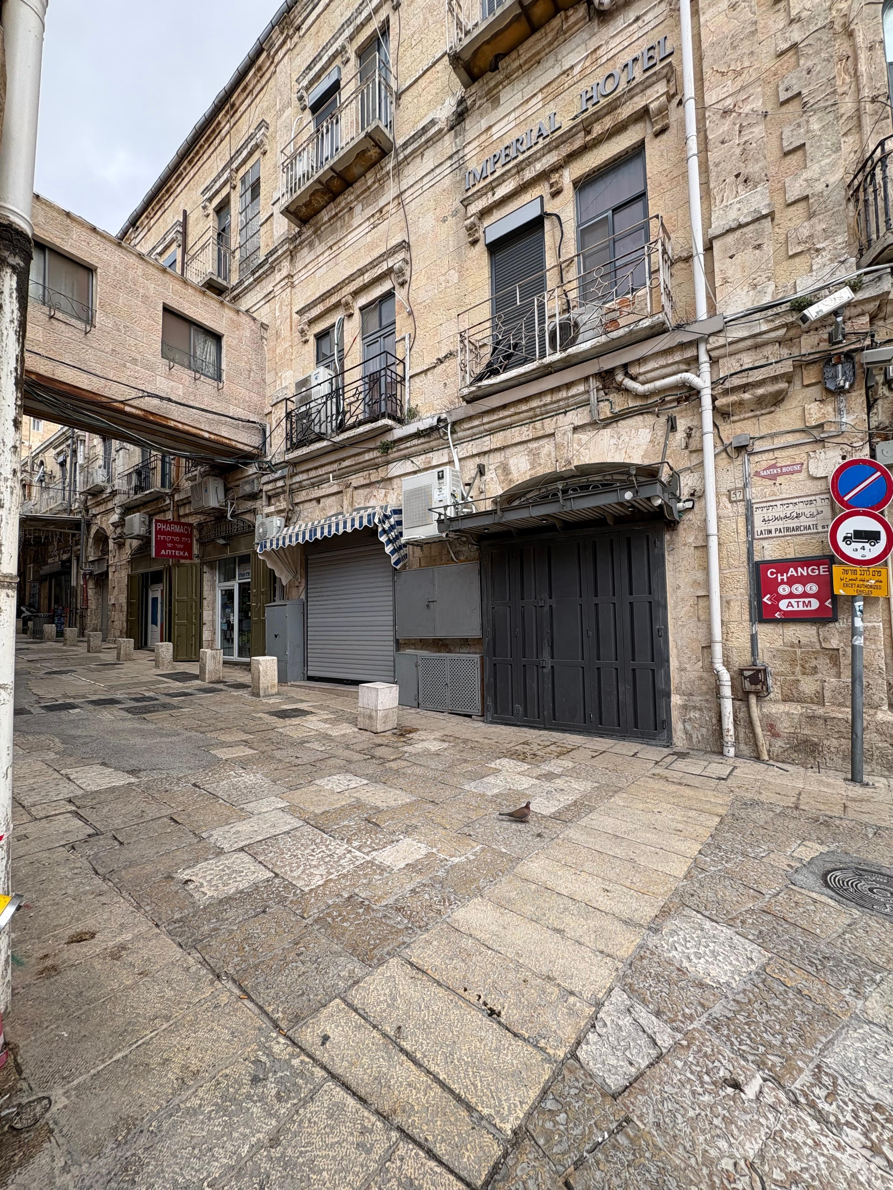 View of pharmacy on side of hotel in alley.  Yes, they sell distilled water for CPAP machines :-) 