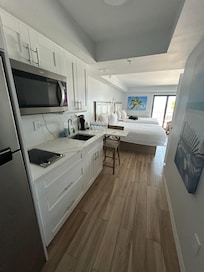 Entrance into our room, full fridge, 2 burners cook top stove, microwave, kitchen sink, fully stocked kitchen ware.