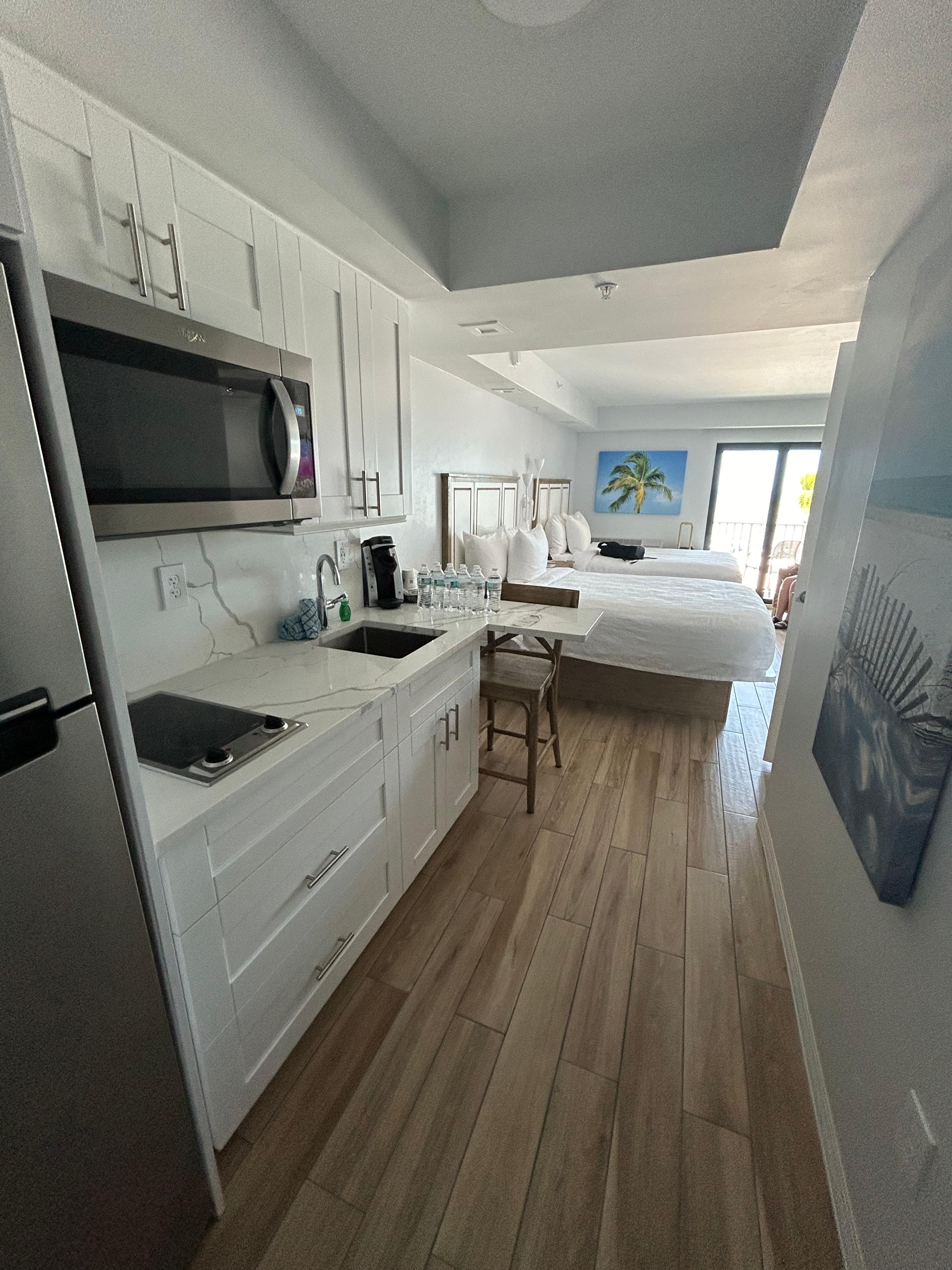 Entrance into our room, full fridge, 2 burners cook top stove, microwave, kitchen sink, fully stocked kitchen ware.