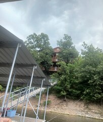 Two balconies on back of house facing lake. All kinds of outdoor furniture. Large dock in a fun cove on Grand Lake.