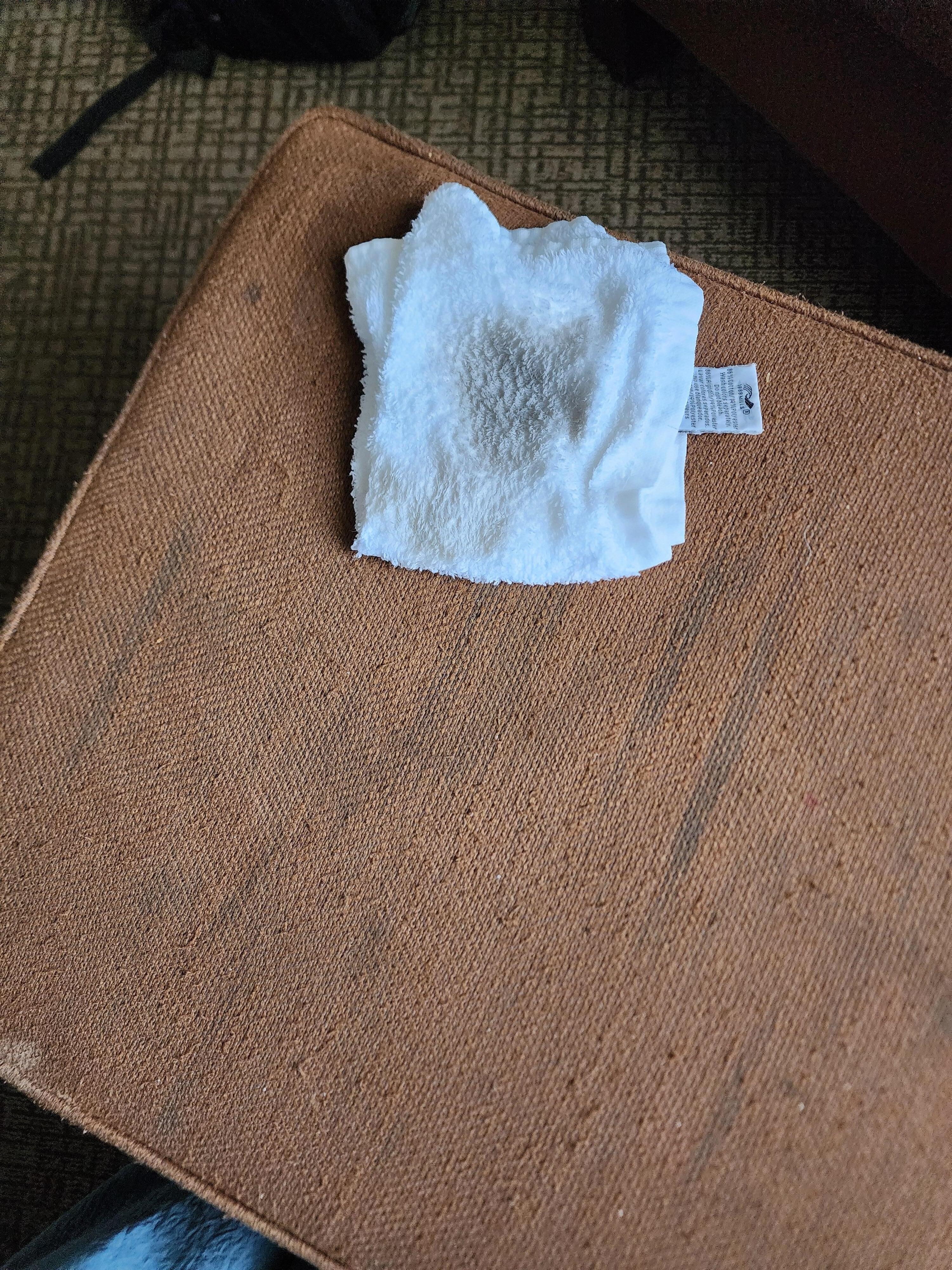 The worn out footrest for the chair in the room- and the rag showing how filthy my feet (after being washed just before bed and only walking around a bit to pack up and then washing before putting on my shoes) were from the floor. 