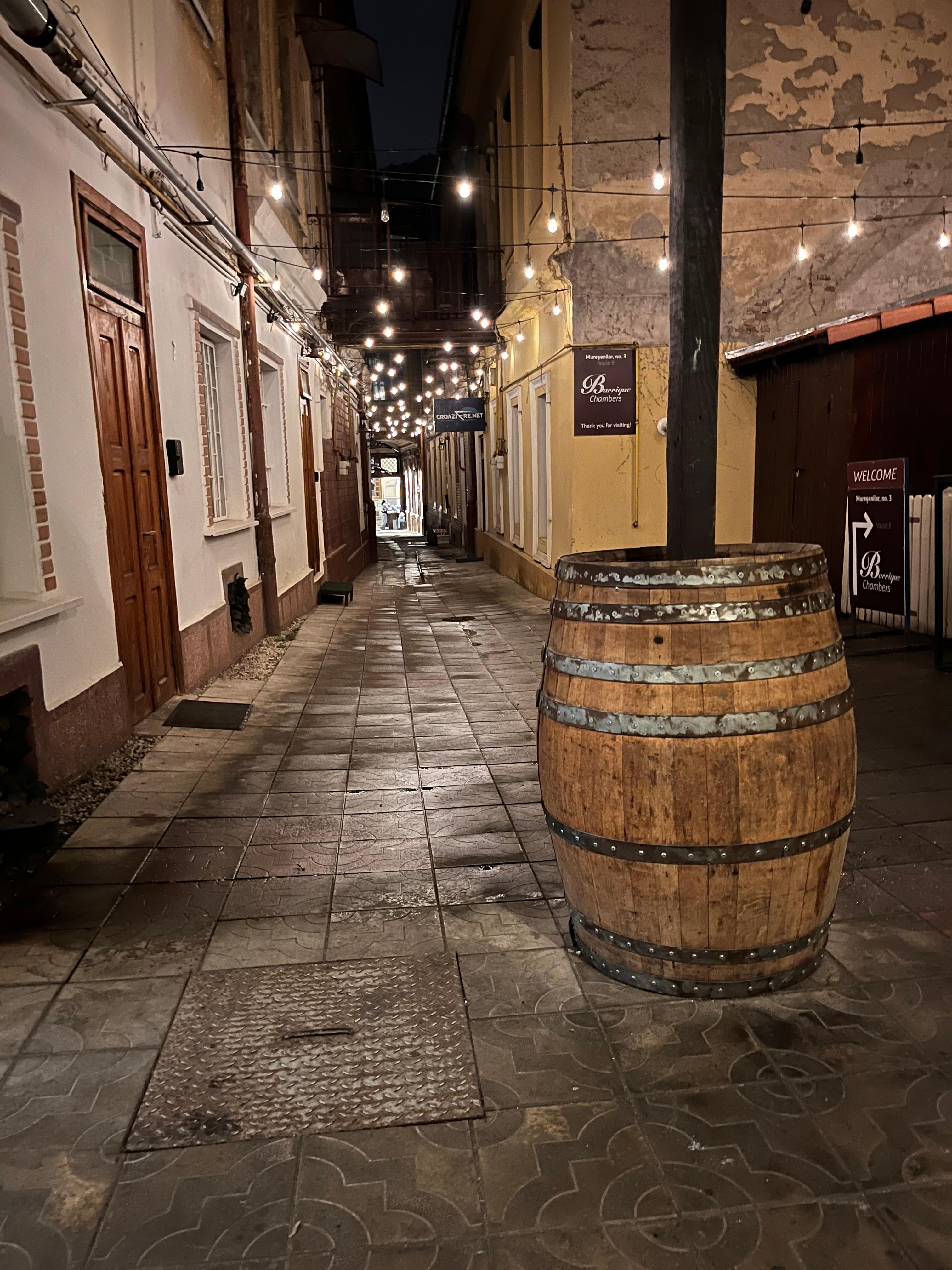 View of the hotel entrance through a narrow alleyway.
