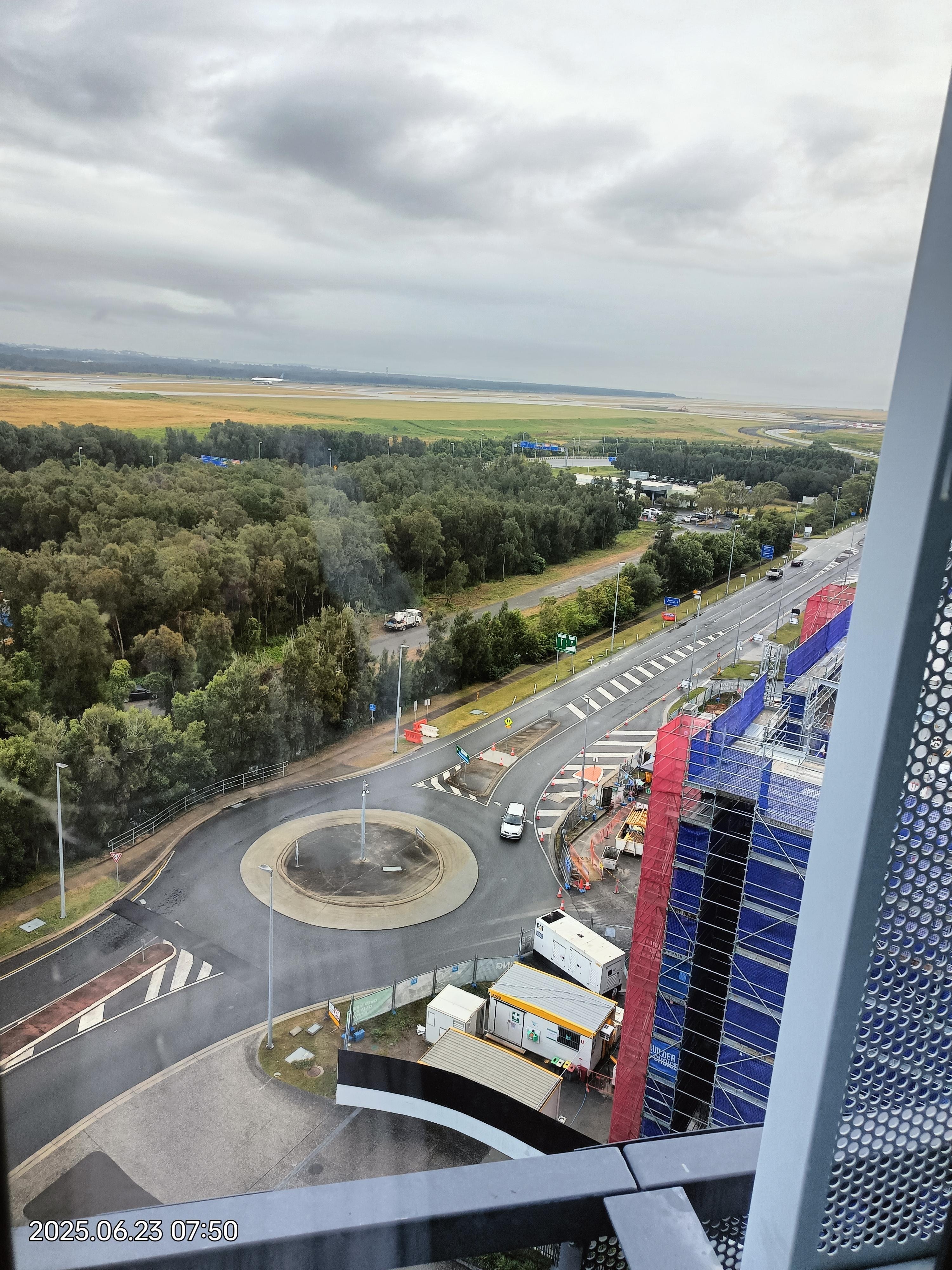 Looking at the view, of the lovely pool, and can see a plane on the runway 9th Floor.. awesome 